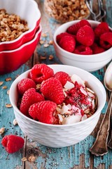 Healthy breakfast bowl granola with greek yogurt, fresh raspberries and chia seeds