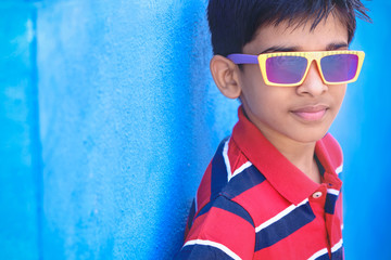 Attractive Indian young boy model posing to camera with glasses
