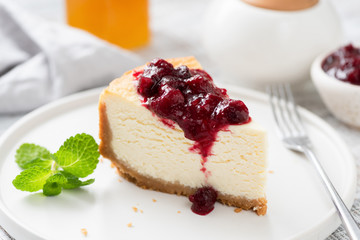Tasty New York Cheesecake With Cherry Sauce On White Plate, Closeup View