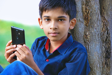 Indian little boy using the cellphone 