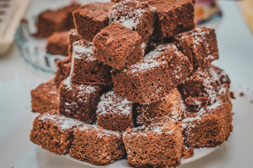 a cake of slices of baked pie with chocolate folded into each other in the form of a pyramid or fir tree. Festive Candy Bar at the Wedding. Selective focus
