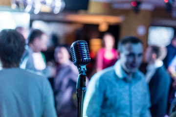 Retro microphone on stage in a pub or American Bar(restaurant) during a night show - obrazy, fototapety, plakaty