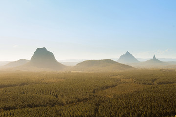 Panorama of Glass House Mountains with fog covering the picturesque mountains during daytime...