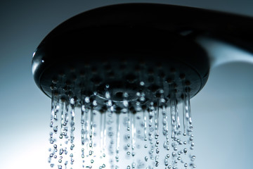 Fototapeta na wymiar Shower head and falling water drops.
