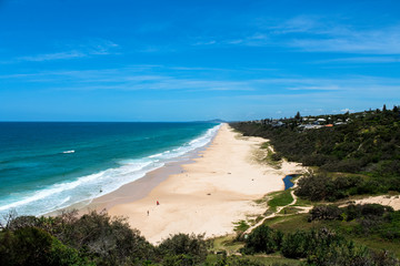 View onto Sunshine Beach from Noosa National Park with clear blue sky during beautiful summer day (Noosa Heads, Queensland, Australia)