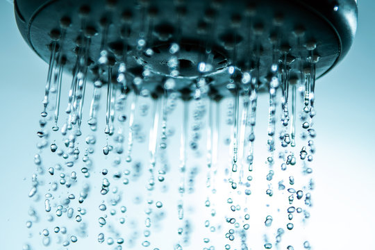 Shower head and falling water drops. © Janis Smits