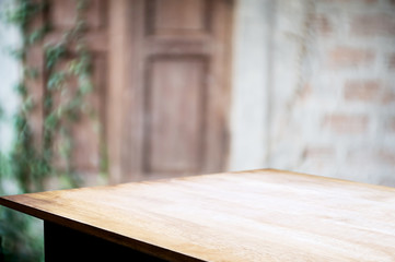 empty wooden table with blurred outdoor garden background