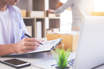 Businessman Shop owner check Order or list inventory in stock which is going to be delivery room. business online, e-commerce concept.