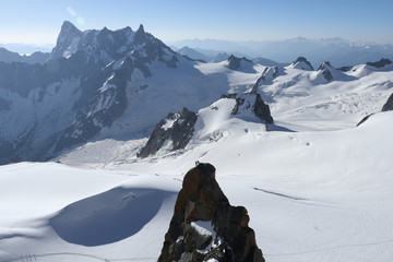 Fototapeta na wymiar Two climbers reach peak at Aiguille du Midi, Chamonix, France