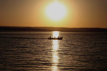 sunset on the lake Fishermen Twilight signals Coconut tree at sunset Beach showers