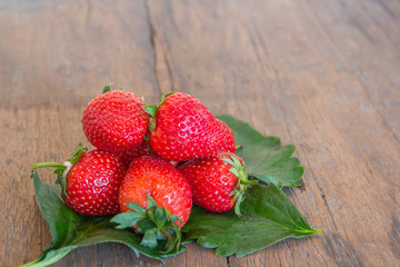 Fresh red strawberry on wood background