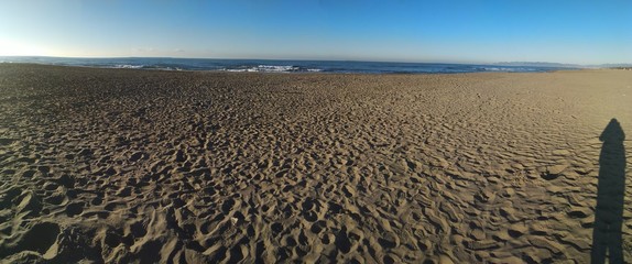 long sea view on a winter morning. the sandy lonely beach makes the photo more suggestive.