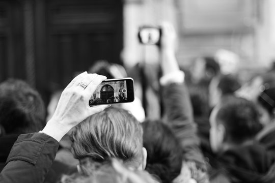 People are waiting for a star. The crowd shoots a star on the phone. Paparazzi everywhere. Journalists are waiting for a star near the hotel