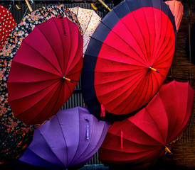 A colorful arrangement of rainy day opened umbrellas in Kyoto, Japan.