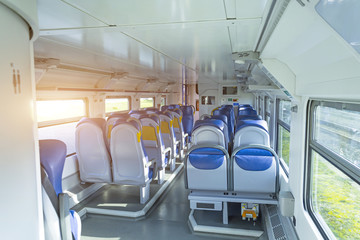 Fototapeta premium Salon inside of the speed commuter train with empty seats.