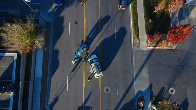 Aerial down to an rollover accident in the middle of the road. 