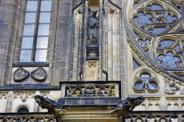Fototapeta na wymiar Close view of the sculptures on the outer walls of St. Vitus Cathedral at Prague, Czech Republic