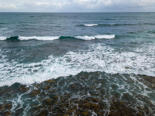 Aerial view of ocean waves and rocky coast in South Africa