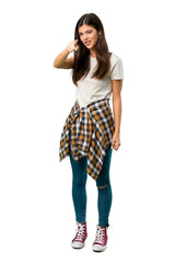 A full-length shot of a Teenager girl with shirt tied to the waist frustrated by a bad situation and pointing to the front