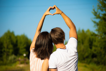 loving couple walking along train rails on a sunny day