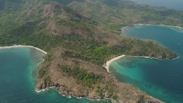 Aerial view coastline with tropical beach, island Limbones, lagoons and coral reefs. Neela cove, Philippines, Luzon. Coast ocean with turquoise water. Tropical landscape in Asia.