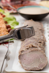 tray of sliced meat and sauce in the buffet