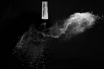 Fototapeta premium Cosmetic brush with white cosmetic powder spreading for makeup artist or graphic design in black background