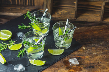 Fresh cocktail with lime, ice and rosemary