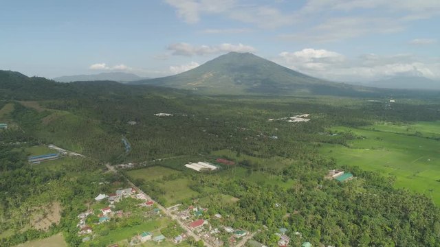 Aerial view town in mountain valley at foot mountain Iriga. Luzon, Philippines. Mountainous tropical landscape.