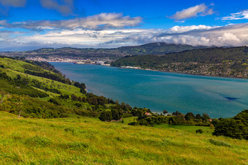 New Zealand, South Island. Otago Harbour and slope of Otago Peninsula, Dunedin city in the backgroun 