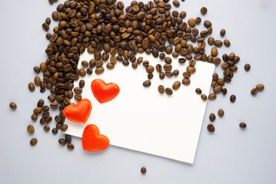 Creative concept valentine day photo of coffee beans with heart and paper list card on grey background.