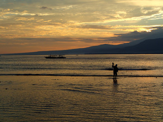 fisherman with boat at sunrise on Gili Air - Bali