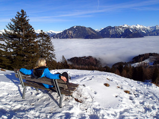 magical winter landscape with fog (inversion weather) in the Alps 2 - beautiful girl looks into the country - Vorarlberg Austria