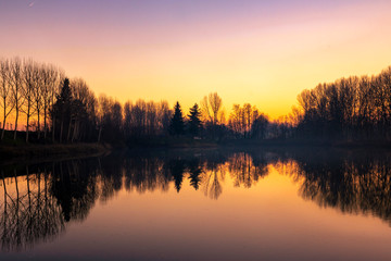 Fototapeta premium Piedmont, Italy, lakefront at sunset, in the park of the river po