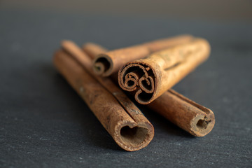 cinnamon sticks isolated on dark textured background