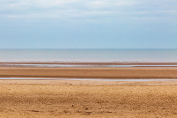 Looking out to sea over a sandy beach, at Formby, Merseyside