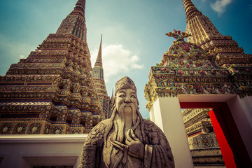 wat Pho themple in Bangkok, Thailand on sunny day outdoors.