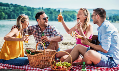 Group of friends having fun on the beach. Lifestyle, vacation concept