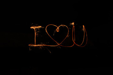 The inscription I Love you and heart of sparclers