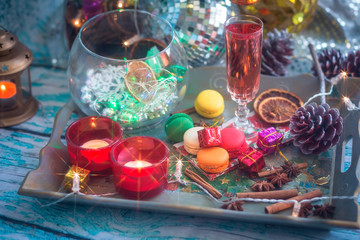 Christmas still life with glass of wine and macaroons