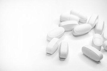 white medical pills, on white background, close-up