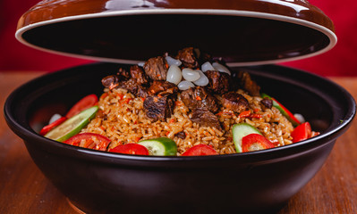 Tagine with traditional uzbek pilaf. Close up