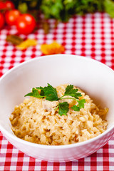 Risotto with mushrooms on white plate. Close up
