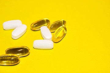 colorful medical pills, on yellow background, closeup