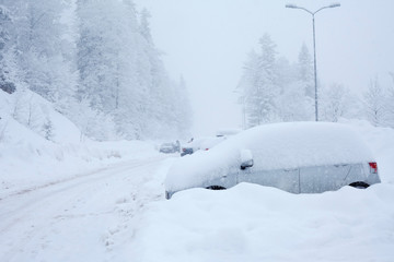 Fototapeta na wymiar Car under the snow on a parking lot