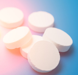 White pills over blue background