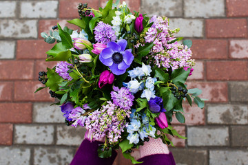 Woman holding beautiful bouquet of flowers