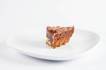 Chocolate cake - a slice on a plate on a white background