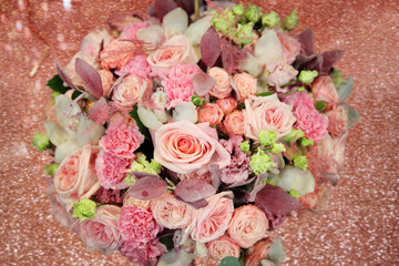 Obraz na płótnie Canvas Huge beautiful light pink bouquet with roses on a shiny background