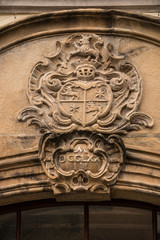 Old historical building with coats of arms made of stone